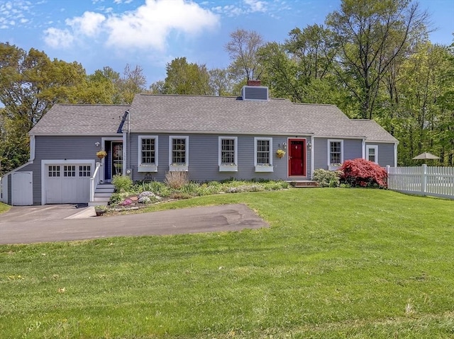 view of front of property featuring a chimney, driveway, a garage, cooling unit, and roof with shingles