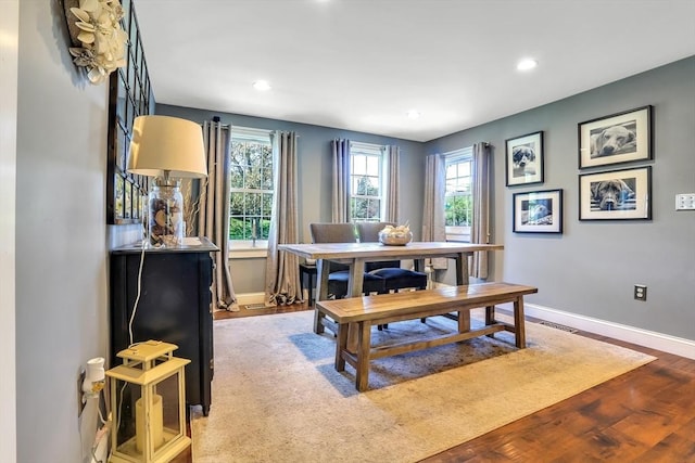 dining area with wood finished floors, baseboards, and recessed lighting