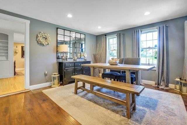 dining room with wood finished floors, baseboards, and recessed lighting