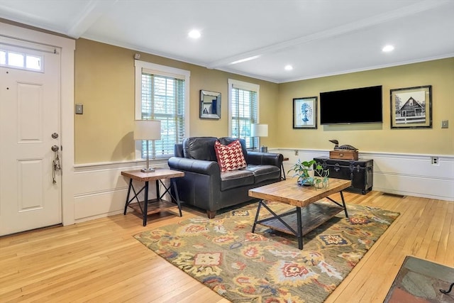 living area featuring wood-type flooring, crown molding, a wainscoted wall, and recessed lighting