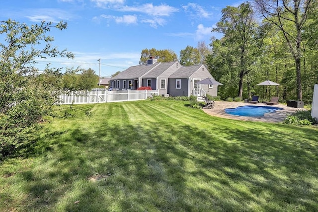 back of property with a chimney and a patio