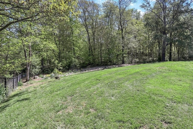 view of yard featuring a forest view