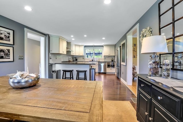 dining space featuring recessed lighting and dark wood-style flooring