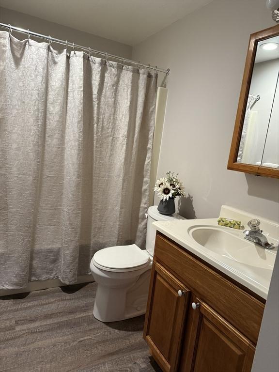 50 Juniper Rd Unit 1C, North Attleboro, MA 02760 - full bath featuring toilet, vanity, wood finished floors, and curtained shower