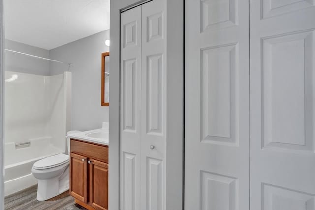 50 Juniper Rd Unit 1C, North Attleboro, MA 02760 - bathroom with a closet, vanity, toilet, wood finished floors, and shower / bath combination
