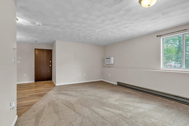 50 Juniper Rd Unit 1C, North Attleboro, MA 02760 - carpeted empty room with a baseboard heating unit, baseboards, a smoke detector, and a textured ceiling