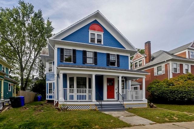 view of front of house featuring a front yard and covered porch