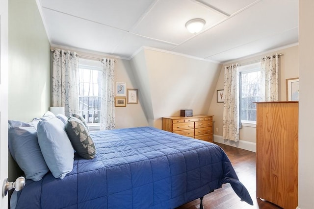 bedroom featuring dark wood-style flooring, crown molding, and baseboards