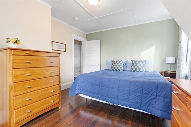 bedroom with ornamental molding, dark wood-style flooring, and baseboards