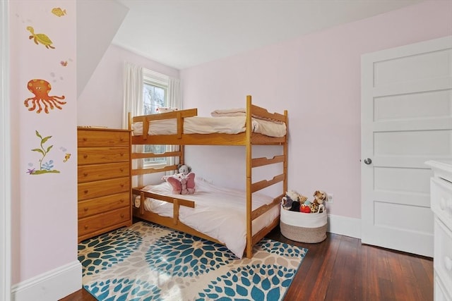 bedroom featuring dark wood finished floors and baseboards