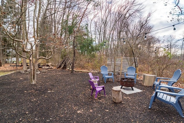 view of yard with a fire pit