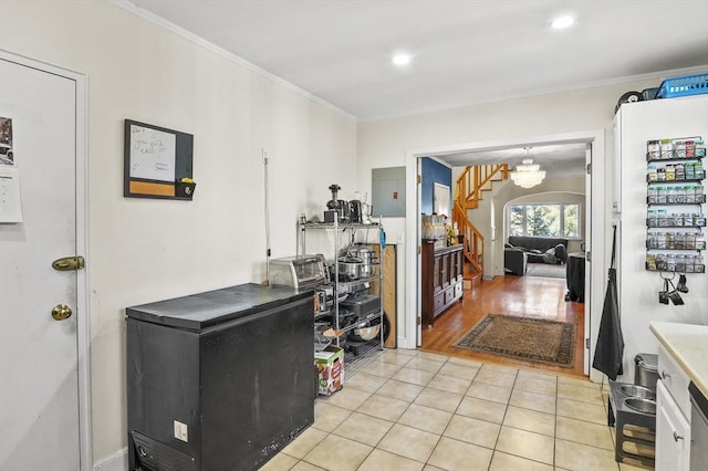 interior space featuring light tile patterned flooring, electric panel, and crown molding