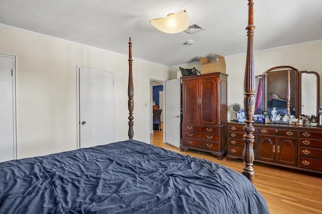 bedroom with ornamental molding and light wood-type flooring