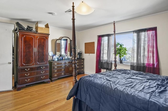 bedroom with ornamental molding and light wood-type flooring