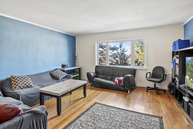 living room with crown molding and light hardwood / wood-style floors