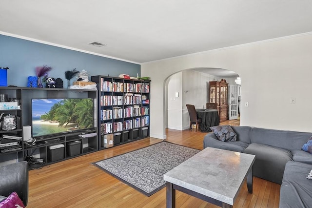 living room with hardwood / wood-style flooring and ornamental molding