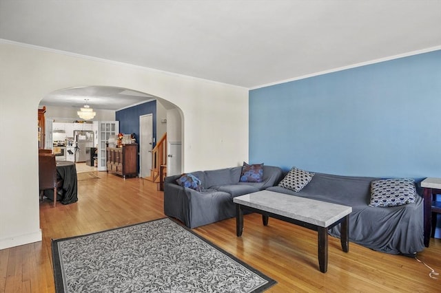 living room with wood-type flooring and ornamental molding