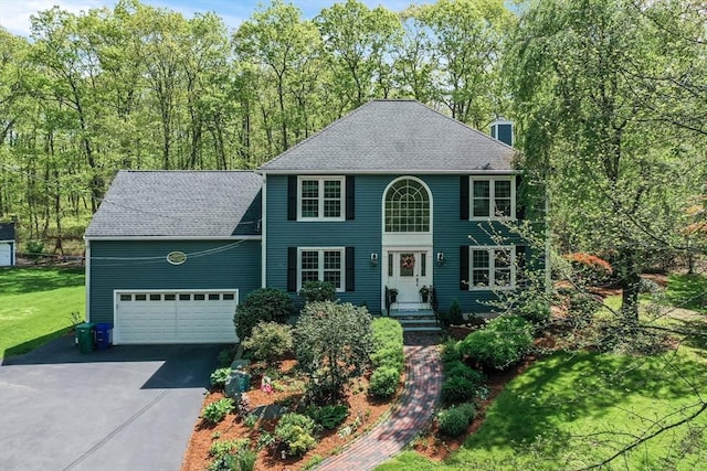 8 Rock Rd, Attleboro, MA 02703 - colonial home featuring asphalt driveway, a chimney, a front yard, an attached garage, and a shingled roof