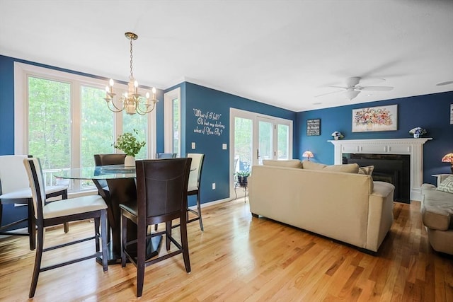 8 Rock Rd, Attleboro, MA 02703 - dining area featuring a chandelier, light wood-style floors, a ceiling fan, and a fireplace