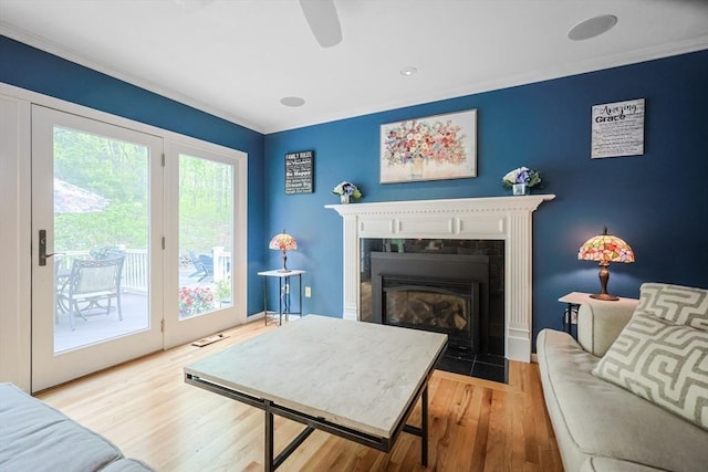 8 Rock Rd, Attleboro, MA 02703 - living area with wood finished floors, a fireplace with flush hearth, crown molding, a ceiling fan, and baseboards