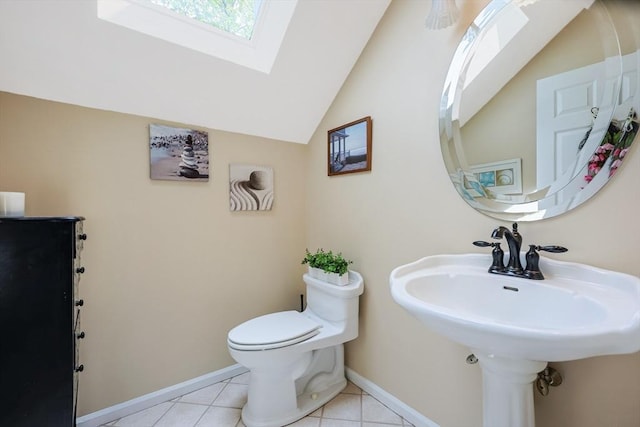 8 Rock Rd, Attleboro, MA 02703 - half bath featuring a skylight, toilet, lofted ceiling, baseboards, and tile patterned flooring