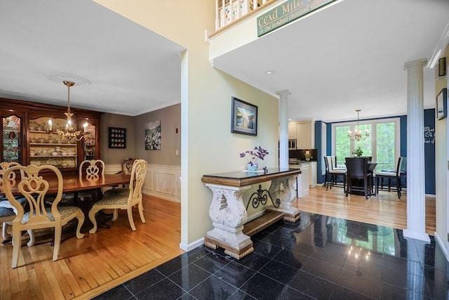 8 Rock Rd, Attleboro, MA 02703 - dining space featuring ornate columns, granite tiled floors, a chandelier, ornamental molding, and wainscoting