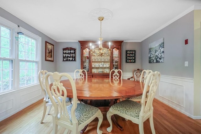 8 Rock Rd, Attleboro, MA 02703 - dining area featuring light wood-type flooring, a chandelier, a wainscoted wall, a decorative wall, and crown molding