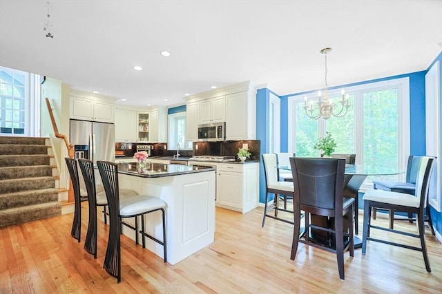 8 Rock Rd, Attleboro, MA 02703 - kitchen featuring stainless steel appliances, a sink, a chandelier, tasteful backsplash, and light wood-style flooring