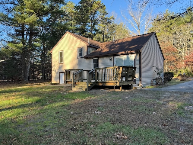 back of house with a lawn and a deck