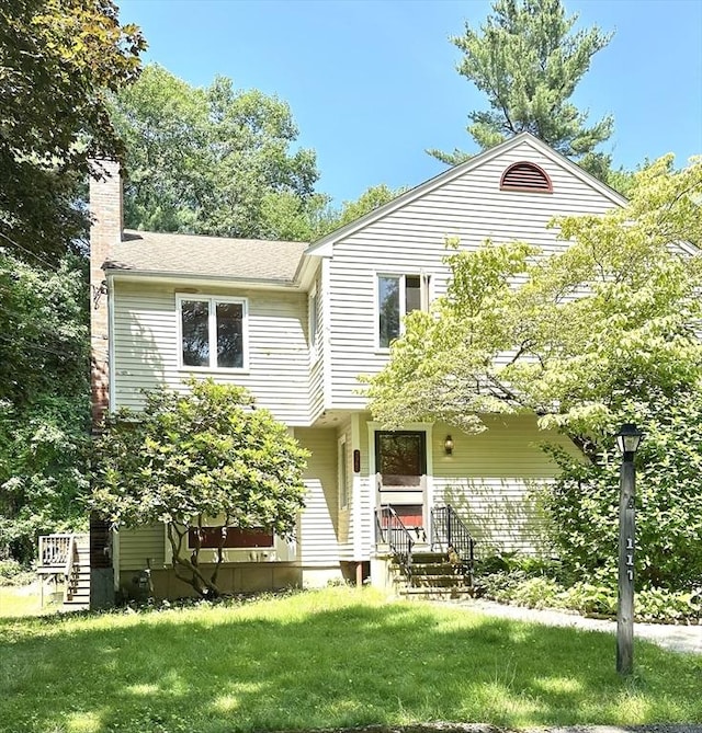 117 Metropolitan Ave Unit 117, Ashland, MA 01721 - view of front of house featuring a chimney, a front yard, entry steps, and a shingled roof