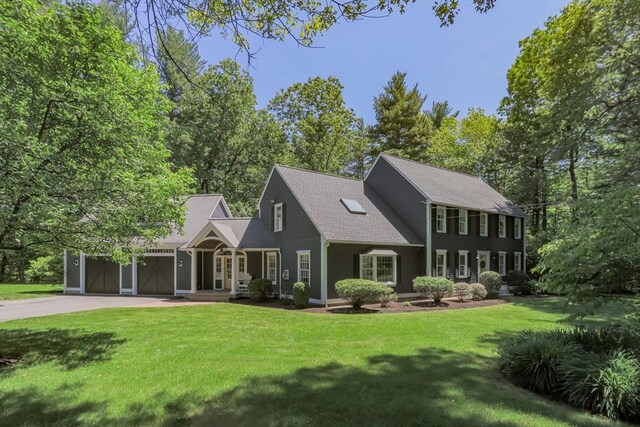 8 Whitaker Ln, Groton, MA 01450 - view of front facade with concrete driveway, a front yard, and an attached garage