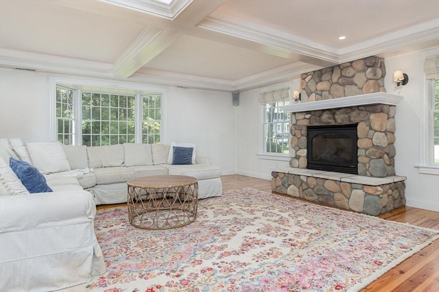 8 Whitaker Ln, Groton, MA 01450 - living area featuring wood finished floors, healthy amount of natural light, ornamental molding, beam ceiling, and a stone fireplace