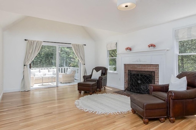 8 Whitaker Ln, Groton, MA 01450 - living room with vaulted ceiling, healthy amount of natural light, a fireplace, and light wood-style floors