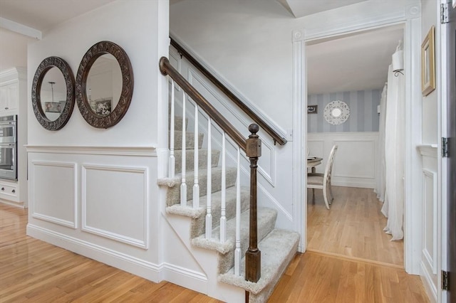 8 Whitaker Ln, Groton, MA 01450 - stairway with a decorative wall, wood finished floors, and wainscoting