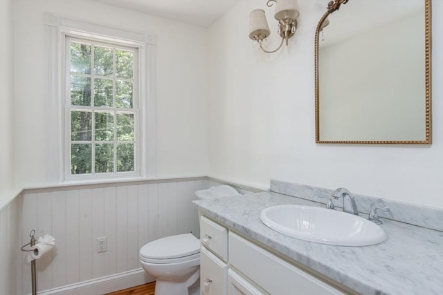 8 Whitaker Ln, Groton, MA 01450 - bathroom with wainscoting, vanity, a chandelier, toilet, and wood walls