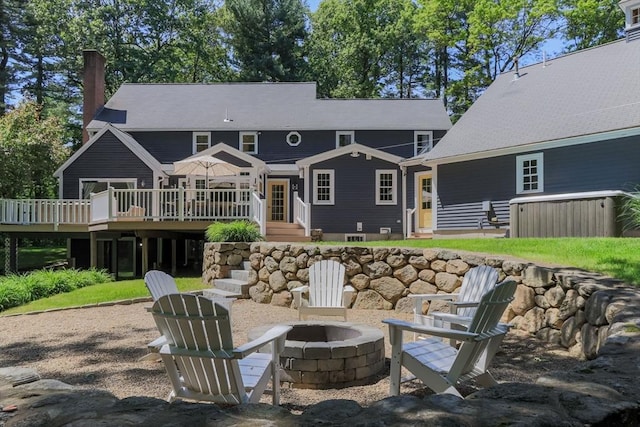 8 Whitaker Ln, Groton, MA 01450 - rear view of house featuring a fire pit, a deck, and a chimney