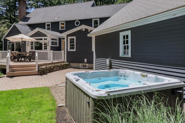 8 Whitaker Ln, Groton, MA 01450 - rear view of property with a deck, a hot tub, a shingled roof, outdoor dining space, and a chimney
