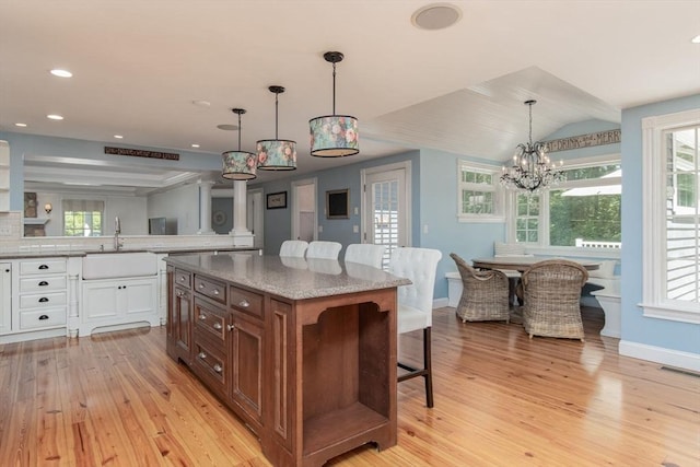 8 Whitaker Ln, Groton, MA 01450 - kitchen featuring a sink, light wood-style floors, a breakfast bar, baseboards, and recessed lighting