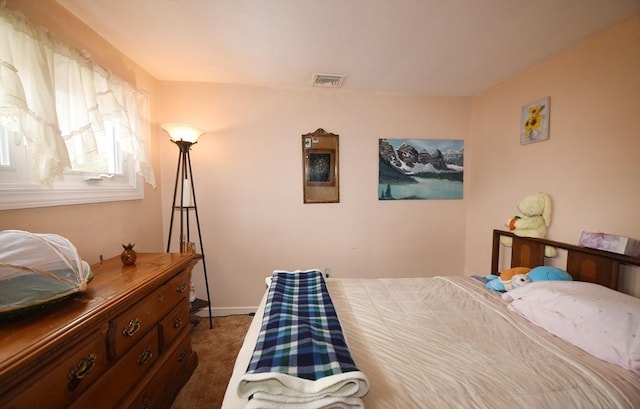 bedroom featuring baseboards, visible vents, and dark carpet