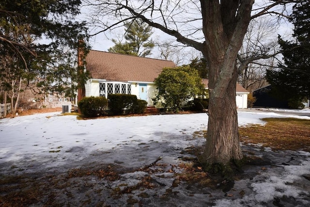 view of front facade featuring a chimney and an outbuilding