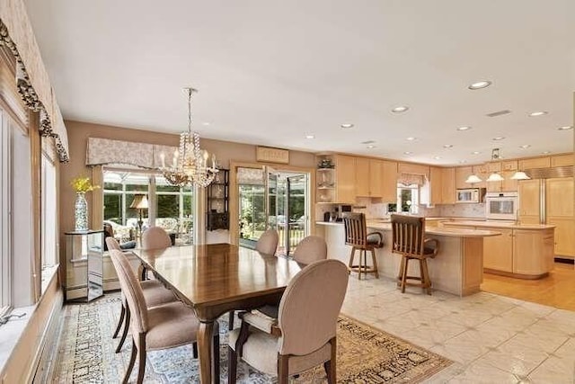 dining room featuring recessed lighting and an inviting chandelier