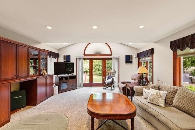 living room with recessed lighting, french doors, light colored carpet, and vaulted ceiling
