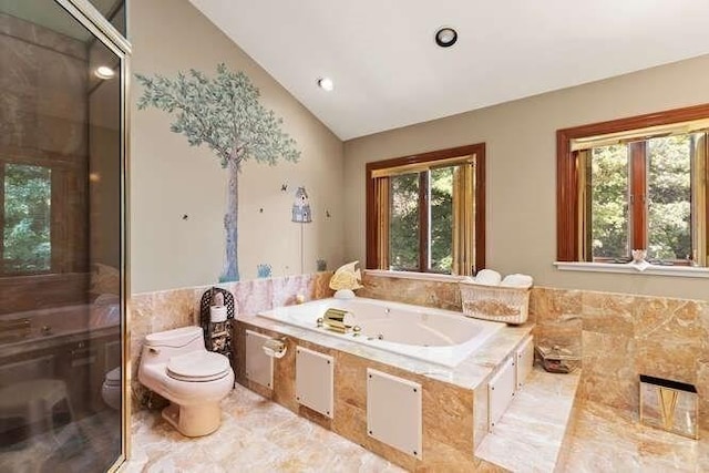 bathroom with toilet, a healthy amount of sunlight, a whirlpool tub, and vaulted ceiling