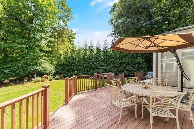 deck featuring a yard and outdoor dining area