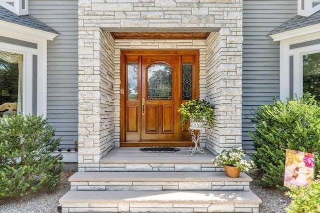 entrance to property with stone siding