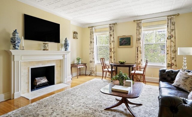 357-359 Beacon St Unit 4, Boston, MA 02116 - living area featuring an ornate ceiling, wood finished floors, a fireplace with raised hearth, crown molding, and baseboards