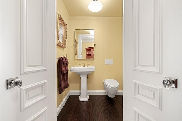 357-359 Beacon St Unit 4, Boston, MA 02116 - half bathroom with toilet, baseboards, wood finished floors, and a sink