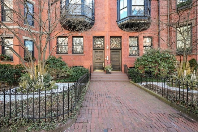 357-359 Beacon St Unit 4, Boston, MA 02116 - view of exterior entry featuring brick siding and fence