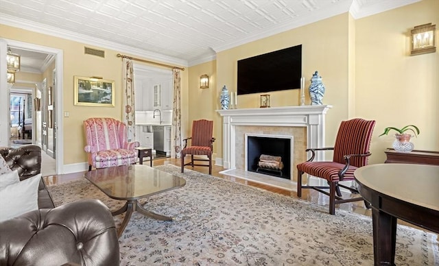 357-359 Beacon St Unit 4, Boston, MA 02116 - living area with baseboards, visible vents, crown molding, wood finished floors, and a tile fireplace