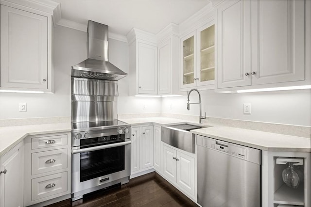 357-359 Beacon St Unit 4, Boston, MA 02116 - kitchen featuring light countertops, a sink, stainless steel appliances, white cabinets, and wall chimney range hood